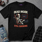 Text "Dead Inside" over illustration of a skeleton wearing headphones sitting at a gaming computer with three loading dots on screen and "Still Queueing" underneath.