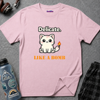 Text "Delicate. Like a Bomb." with cute kawaii kawaii kitty with a lit fuse attached to its tail.