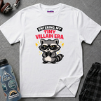 Cute raccoon wearing glasses rubbing hands mischievously with text ENTERING MY TINY VILLAIN ERA