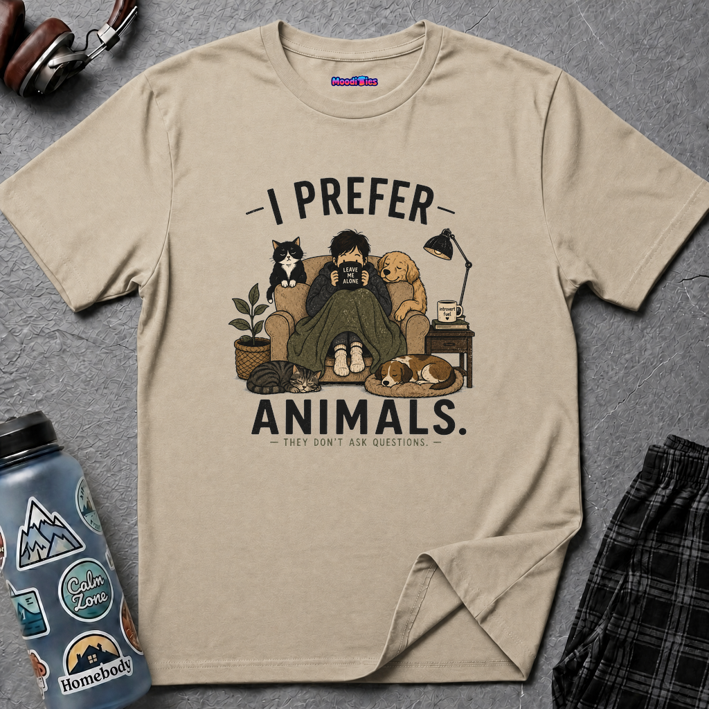 Person with blanket and book, surrounded by three cats and two dogs, under text I Prefer Animals. They Don't Ask Questions.