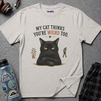 Black grumpy cat with crossed paws looks unimpressed beside person walking away, text My Cat Thinks You're Weird Too.