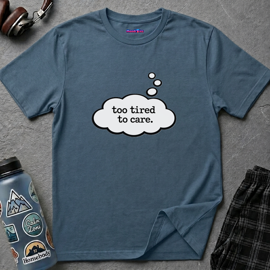 Text "Too Tired To Care" in a cartoon thought bubble drifting down from the wearer's head.